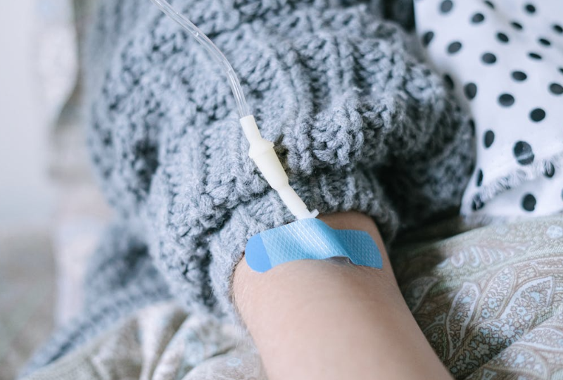 Iron IV therapy infusion on patient’s arm for low iron and fatigue treatment